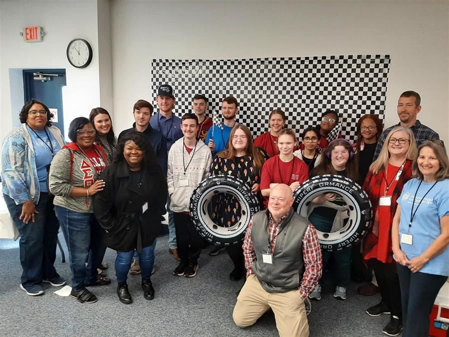 Twenty RACE Tracts attendees hit the brakes long enough to pose for a group photo.